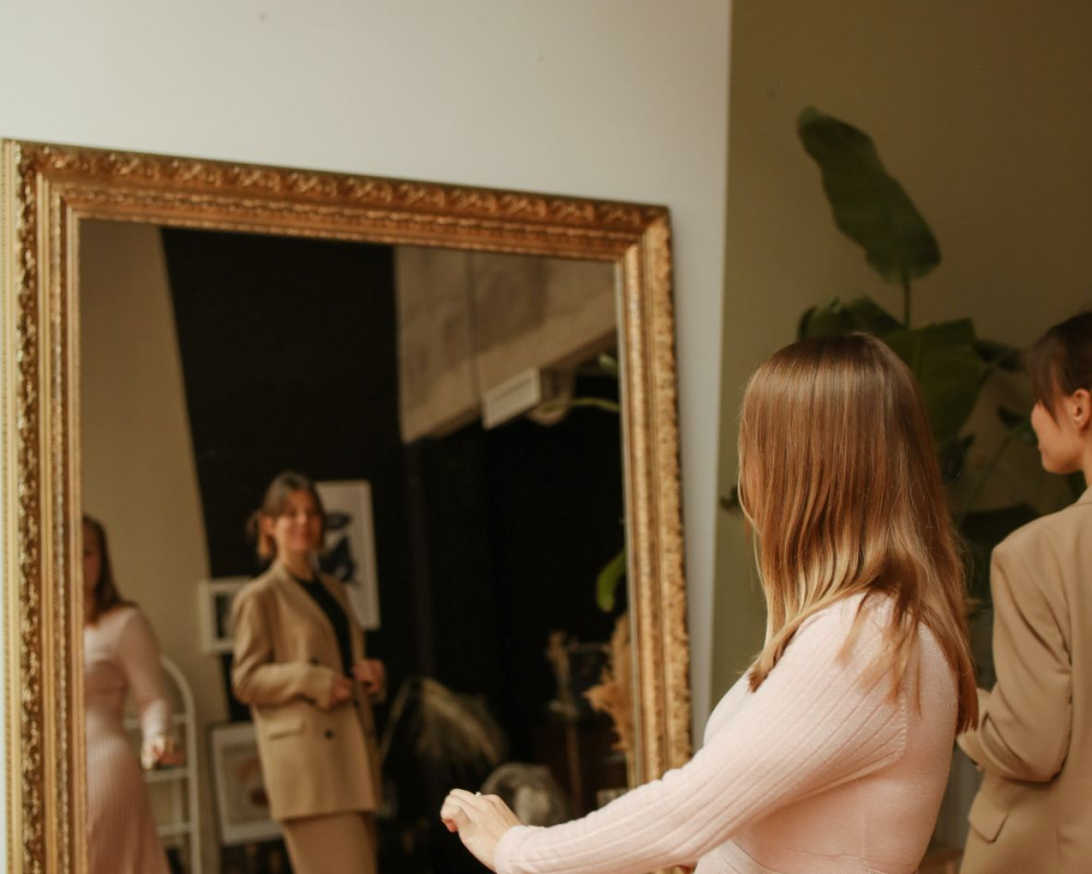 women in front of a mirror