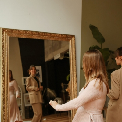 women in front of a mirror