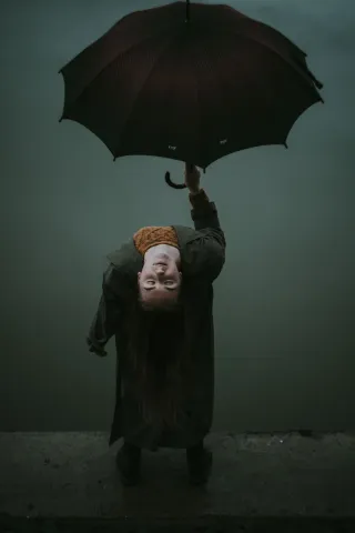 genuine person holding umbrella