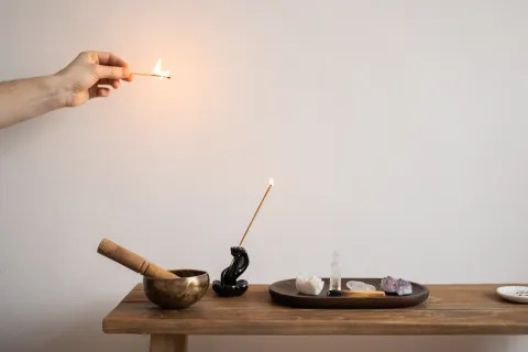 A table of alternative healing implements: incense, crystals.