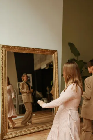 women in front of a mirror